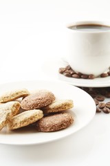 Cup of coffee with cookies and saucer on white