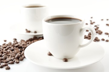 Wave made of coffee beans with cups of coffee