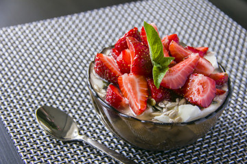 Porridge with fresh strawberries in a glass bowl