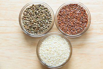 Flax, sesame, and hemp seeds in glass bowls