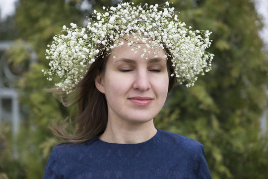 Clouse-up summer portrait beautiful girl with wreath of