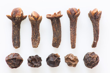 Isolated cloves and black peppers still life