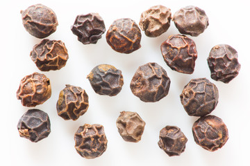 Black peppers isolated close up macro