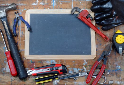 Fathers day image with blackboard and tools on a stained table