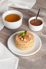 pancakes with nuts, decorated mint for breakfast, vertical