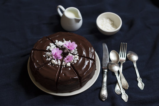 Chocolate Cake Decorated With Meringue Crumbs And Violets 