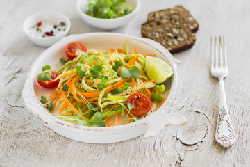 fresh salad with zucchini and carrots in a vintage plate 