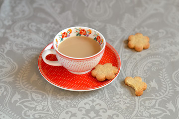Cup of tea and biscuits on a light grey surface