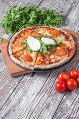 Vegetarian pizza with mozzarella and arugula.