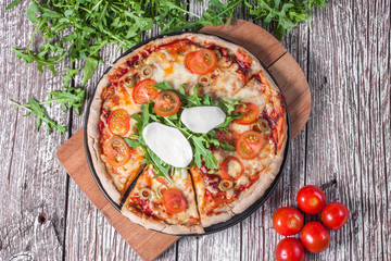 Vegetarian pizza with mozzarella and arugula.