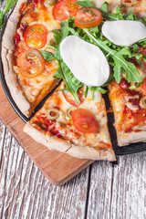 Vegetarian pizza with mozzarella and arugula.