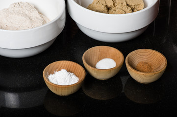 Wooden bowls with spices and ingredients