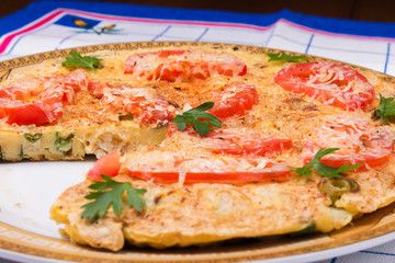 Omelet with cauliflower, tomatoes, fresh herbs and cheese 