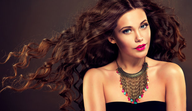 Beautiful model brunette with long curled hair. 