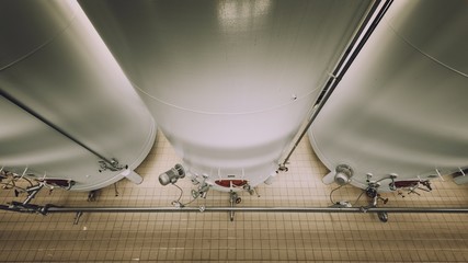 Large industrial white silos in modern factory © Sved Oliver