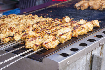 Chicken kebab skewers cooking on a grill