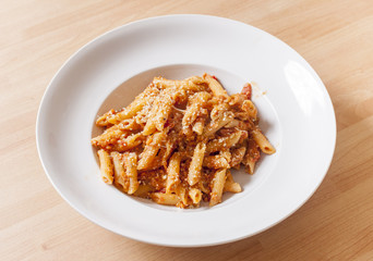 Penne Pasta in tomato sauce in white bowl