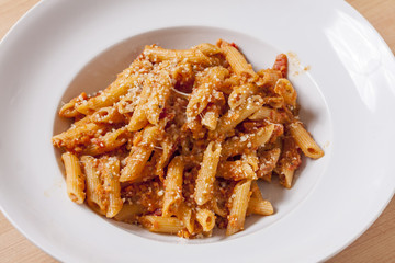 Penne Pasta in tomato sauce in white bowl