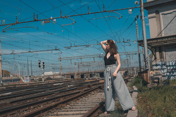 Beautiful brunette posing in an industrial context