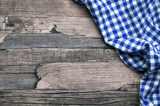 Wooden table with checkered tablecloth picnic dinner oktoberfest background