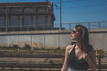 Beautiful brunette posing in an industrial context