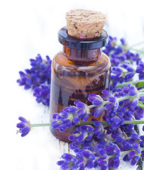 Obraz na płótnie Canvas lavender oil with fresh flowers on the wooden table