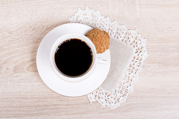 White coffee cup with biscuit