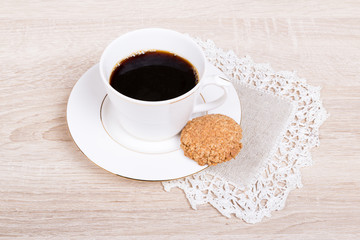 White coffee cup with biscuit