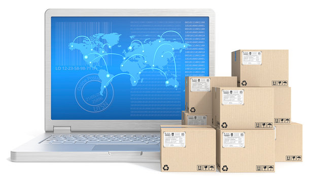 Laptop with globl map screen and pile of cardboard boxes.