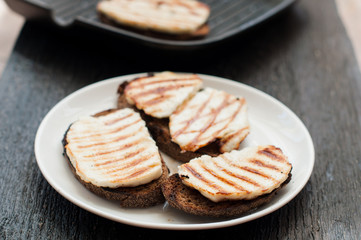 Crostini with fried cheese on the grill
