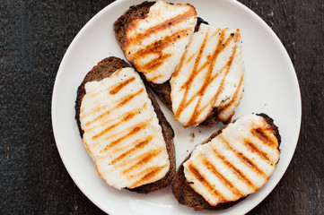 Crostini with fried cheese on the grill