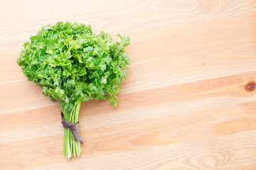 Fresh parsley on a light wooden background