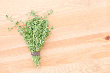 Fresh thyme on a light wooden background