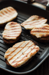Crostini with fried cheese on the grill