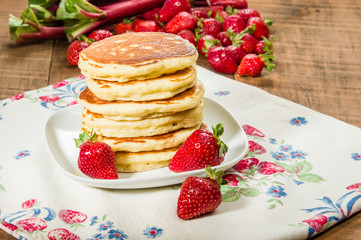 Pancakes with strawberries on plate