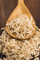 Spoon of brown rice close up