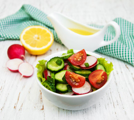 Spring salad with tomato, cucumbers and radish