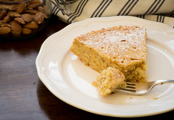 Lemon Almond Cake Slice with Fork on White Plate