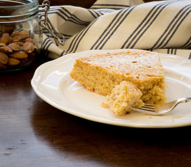 Lemon Almond Cake Slice with Fork on White Plate