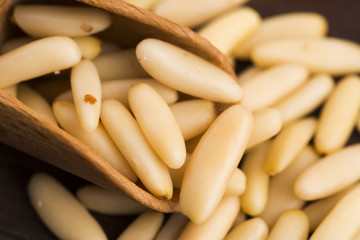Dry Organic Pine Nuts on Wooden Background