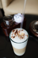 Transparent glass with latte in a cafe