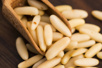 Dry Organic Pine Nuts on Wooden Background