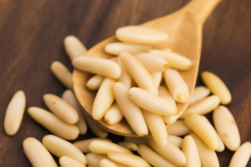 Dry Organic Pine Nuts on Wooden Background