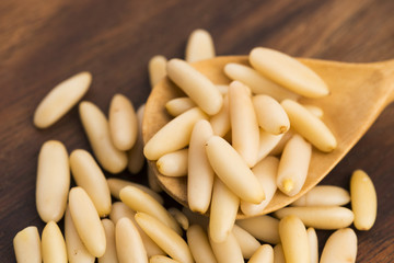 Dry Organic Pine Nuts on Wooden Background