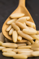 Dry Organic Pine Nuts on Wooden Background