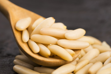 Dry Organic Pine Nuts on Wooden Background