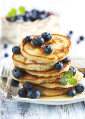 Stack of pancakes with fresh blueberry and honey