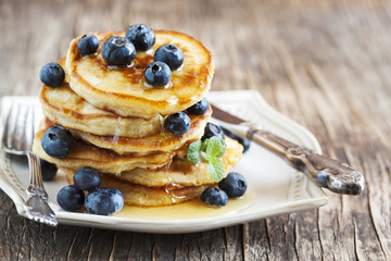 Stack of pancakes with fresh blueberry and honey