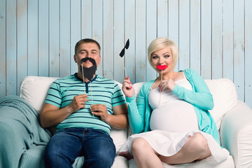 Pregnant couple with false mustaches