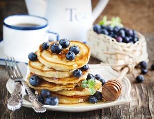 Stack of pancakes with fresh blueberry and honey